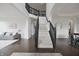 Grand foyer with dark hardwood floors, staircase with black banister, and open archways leading to other rooms at 15201 Slateford Rd, Noblesville, IN 46062