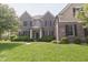 Charming two-story brick home with a well-manicured lawn and neatly trimmed hedges at 15201 Slateford Rd, Noblesville, IN 46062