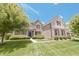 Attractive brick home with shutters, lush lawn, and well-maintained landscaping creates inviting curb appeal at 15201 Slateford Rd, Noblesville, IN 46062