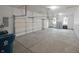 The garage features two overhead doors, concrete flooring, shelving and windows at 15201 Slateford Rd, Noblesville, IN 46062