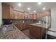 Kitchen featuring wood cabinets, granite countertops, stainless steel appliances, and an island with seating at 15201 Slateford Rd, Noblesville, IN 46062