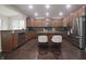 Kitchen featuring wood cabinets, stainless steel appliances, and a granite-topped island with seating at 15201 Slateford Rd, Noblesville, IN 46062