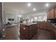 Open kitchen flows into the living space with island and stainless steel appliances at 15201 Slateford Rd, Noblesville, IN 46062