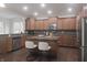 Kitchen featuring wood cabinets, stainless steel appliances, and a granite-topped island with seating at 15201 Slateford Rd, Noblesville, IN 46062