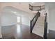 Open-concept living space with staircase, hardwood flooring, archways and upstairs railing at 15201 Slateford Rd, Noblesville, IN 46062