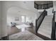 Bright and airy living room featuring dark wood floors, neutral furniture, and staircase with black banister at 15201 Slateford Rd, Noblesville, IN 46062
