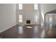 Spacious living room with dark hardwood floors, fireplace, and large windows for natural light at 15201 Slateford Rd, Noblesville, IN 46062