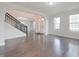 Open living area with arched doorways, hardwood floors, staircase and natural light at 15201 Slateford Rd, Noblesville, IN 46062