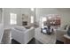Spacious living room with hardwood floors, a fireplace, neutral furniture, and open layout flowing into the kitchen at 15201 Slateford Rd, Noblesville, IN 46062