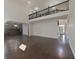 Spacious living area showcasing the staircase with black railing, kitchen, and hardwood floors at 15201 Slateford Rd, Noblesville, IN 46062