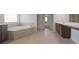 Elegant main bathroom with a soaking tub, tile floors, and separate vanities at 15201 Slateford Rd, Noblesville, IN 46062