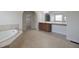 Inviting main bathroom with a soaking tub, wood cabinets, and a walk-in closet at 15201 Slateford Rd, Noblesville, IN 46062