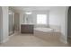 Beautiful bathroom featuring a soaking tub, glass shower, and natural light at 15201 Slateford Rd, Noblesville, IN 46062