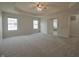 Bright and airy main bedroom features plush carpeting, tray ceilings, and two large windows at 15201 Slateford Rd, Noblesville, IN 46062