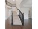 Staircase with carpet steps and a black decorative banister and wood flooring at 15201 Slateford Rd, Noblesville, IN 46062