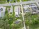 This aerial shot reveals the property's proximity to a business and parking lot, with mature trees surrounding the area at 1535 Whalen Ave, Indianapolis, IN 46227