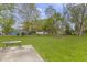 Expansive backyard with lush green grass, mature trees, and a serene, natural setting at 1535 Whalen Ave, Indianapolis, IN 46227