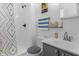 The bathroom features a shower and tub, a toilet, a sink, and decorative shelves and towel racks at 1535 Whalen Ave, Indianapolis, IN 46227