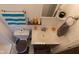 An airy bathroom includes a toilet, vanity with sink, mirror, and shelves with bottles and accessories at 1535 Whalen Ave, Indianapolis, IN 46227