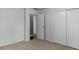 Bedroom with neutral carpet, closet, and an open door, featuring a view to other rooms in the home at 1535 Whalen Ave, Indianapolis, IN 46227