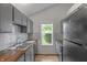 Well-lit kitchen with stainless steel appliances, hardwood counters and backsplash at 1535 Whalen Ave, Indianapolis, IN 46227