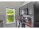 Cozy kitchen with gray subway tile and wooden countertops, creating a rustic-chic feel with views to backyard at 1535 Whalen Ave, Indianapolis, IN 46227