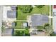 Aerial view of a backyard featuring mature trees, a patio, shed, and two-car garage at 1539 Evans Ave, Noblesville, IN 46060