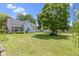 Large backyard with a mature tree, play structure, and well-maintained lawn at 1539 Evans Ave, Noblesville, IN 46060