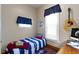 Small bedroom with a single bed and an acoustic guitar on the wall at 1539 Evans Ave, Noblesville, IN 46060