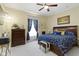 The bedroom has a ceiling fan, large window, and a picture hung on the wall at 1539 Evans Ave, Noblesville, IN 46060