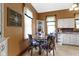 Cozy eat-in kitchen includes decorative chairs, a round table and bright natural lighting at 1539 Evans Ave, Noblesville, IN 46060