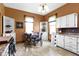 Eat-in kitchen area boasts a quaint table with decorative chairs and white built-in shelves at 1539 Evans Ave, Noblesville, IN 46060
