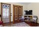 This living room has wood floors, wooden trim, and a TV at 1539 Evans Ave, Noblesville, IN 46060