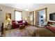 Comfortable living room with rich hardwood floors, a cozy red sofa, and a view into other spaces at 1539 Evans Ave, Noblesville, IN 46060