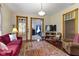 Cozy living room with hardwood floors, a red sofa, and vintage-style decor at 1539 Evans Ave, Noblesville, IN 46060