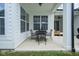 Covered back patio with dining table and four chairs, ideal for outdoor gatherings at 15557 Starflower Dr, Westfield, IN 46074