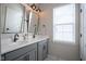 Bathroom featuring double sinks, gray cabinets, and modern fixtures with natural light at 15557 Starflower Dr, Westfield, IN 46074