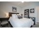 Bright bedroom with a plush bed, decorative pillows, a bookshelf, and black and white photographs at 15557 Starflower Dr, Westfield, IN 46074