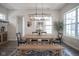 Bright dining room featuring wood table, black chairs, and modern light fixture at 15557 Starflower Dr, Westfield, IN 46074