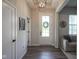 Welcoming entryway with wood flooring, stylish light fixture, and natural light at 15557 Starflower Dr, Westfield, IN 46074
