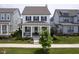 Charming two-story home with a welcoming front porch and manicured lawn and swing at 15557 Starflower Dr, Westfield, IN 46074