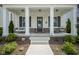 Welcoming front porch with white columns, a comfortable porch swing, and stylish decor at 15557 Starflower Dr, Westfield, IN 46074