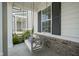 Comfortable porch swing with decorative pillows set against classic black shutters at 15557 Starflower Dr, Westfield, IN 46074