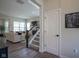 Bright hallway with staircase, a door, and opening to the comfortable living room at 15557 Starflower Dr, Westfield, IN 46074