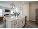 Modern kitchen with island sink, open to the living room, and stainless appliances at 15557 Starflower Dr, Westfield, IN 46074