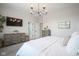 Comfortable main bedroom with gray dressers, TV, and a light and airy feel at 15557 Starflower Dr, Westfield, IN 46074