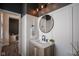 Stylish powder room featuring wood vanity, white walls, and modern black fixtures at 15557 Starflower Dr, Westfield, IN 46074