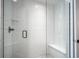 Modern shower with a glass enclosure, white subway tile, pebble floor, and a built-in bench at 15557 Starflower Dr, Westfield, IN 46074