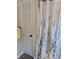 Bright bathroom featuring a decorative shower curtain and built in storage space at 1584 Shady Ln, Columbus, IN 47201