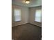 Cozy bedroom with plush carpeting, natural light from multiple windows, and neutral paint at 1584 Shady Ln, Columbus, IN 47201